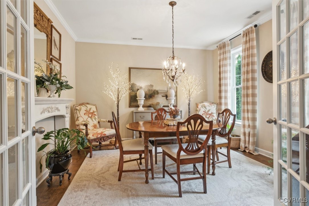 5587 Brixton Road Williamsburg, VA 23185 - Photo 7 of 42 a view of a dining room and livingroom with furniture wooden floor a chandelier