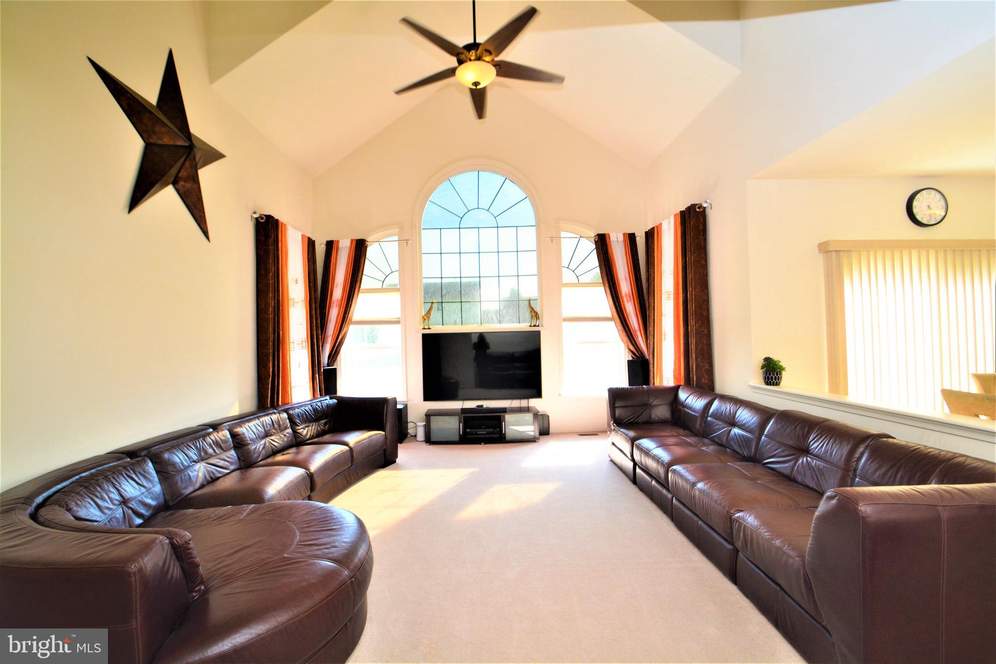 176 Gravelly Run Branch Road Clayton, DE 19938 - Photo 12 of 52 a living room with furniture fireplace and a flat screen tv