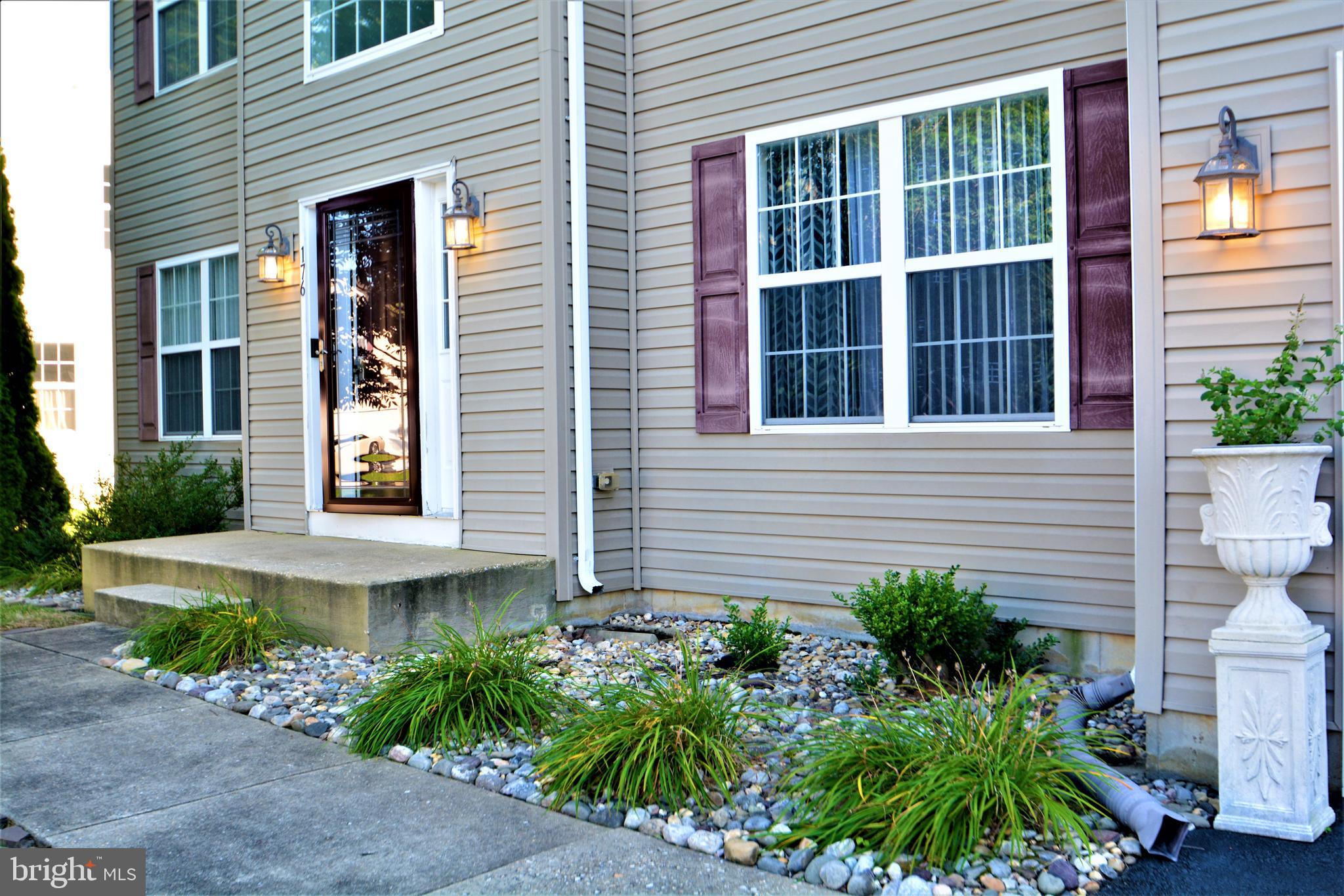 176 Gravelly Run Branch Road Clayton, DE 19938 - Photo 2 of 52 a view of a brick house with plants and windows