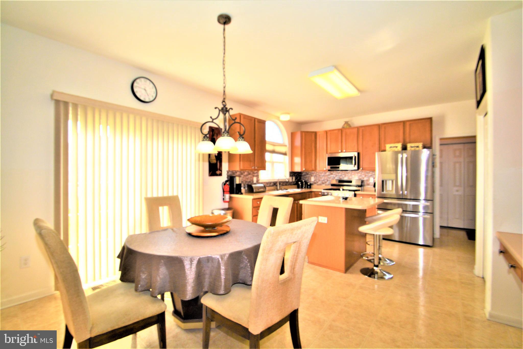 176 Gravelly Run Branch Road Clayton, DE 19938 - Photo 22 of 52 a view of a dining room with furniture wooden floor and a chandelier