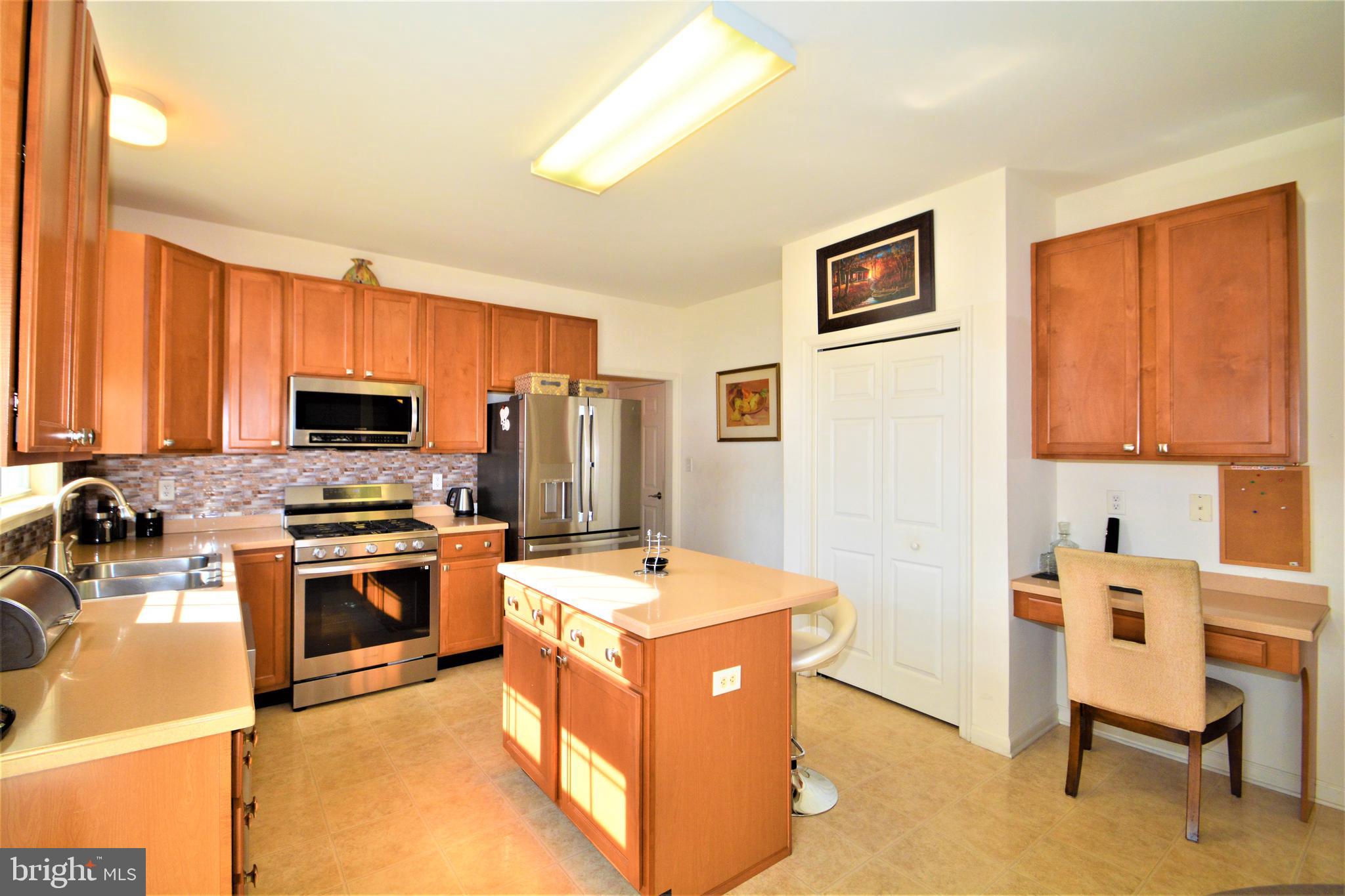 176 Gravelly Run Branch Road Clayton, DE 19938 - Photo 23 of 52 a kitchen with stainless steel appliances granite countertop a stove top oven a sink a dining table and chairs