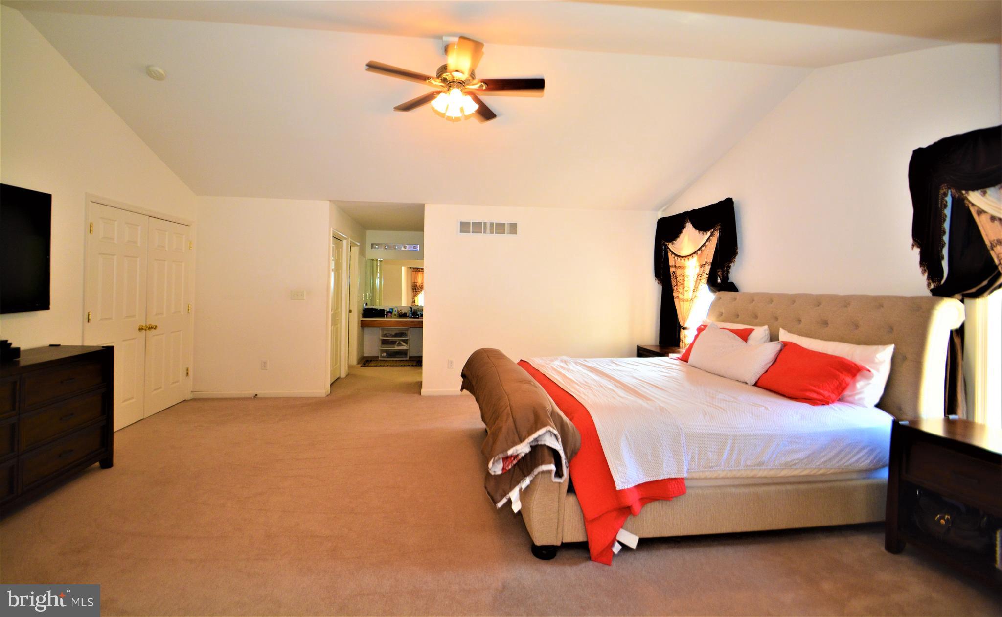 176 Gravelly Run Branch Road Clayton, DE 19938 - Photo 34 of 52 a bedroom with a bed and a chandelier