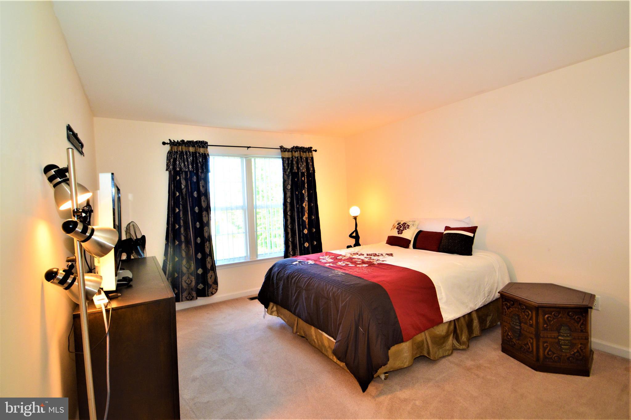 176 Gravelly Run Branch Road Clayton, DE 19938 - Photo 40 of 52 a bedroom with a bed and a window