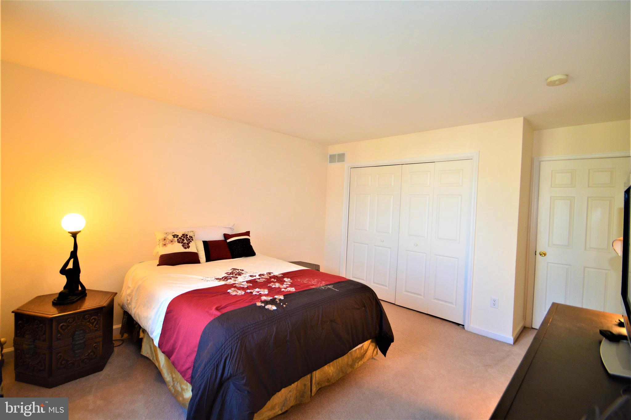 176 Gravelly Run Branch Road Clayton, DE 19938 - Photo 41 of 52 a bedroom with a bed and a lamp