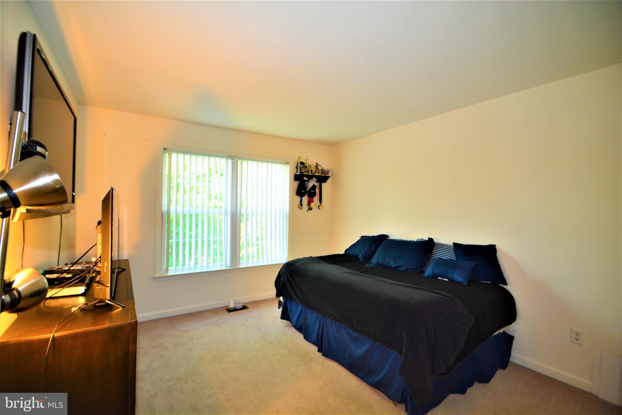 176 Gravelly Run Branch Road Clayton, DE 19938 - Photo 43 of 52 a bedroom with a bed window and a flat screen tv