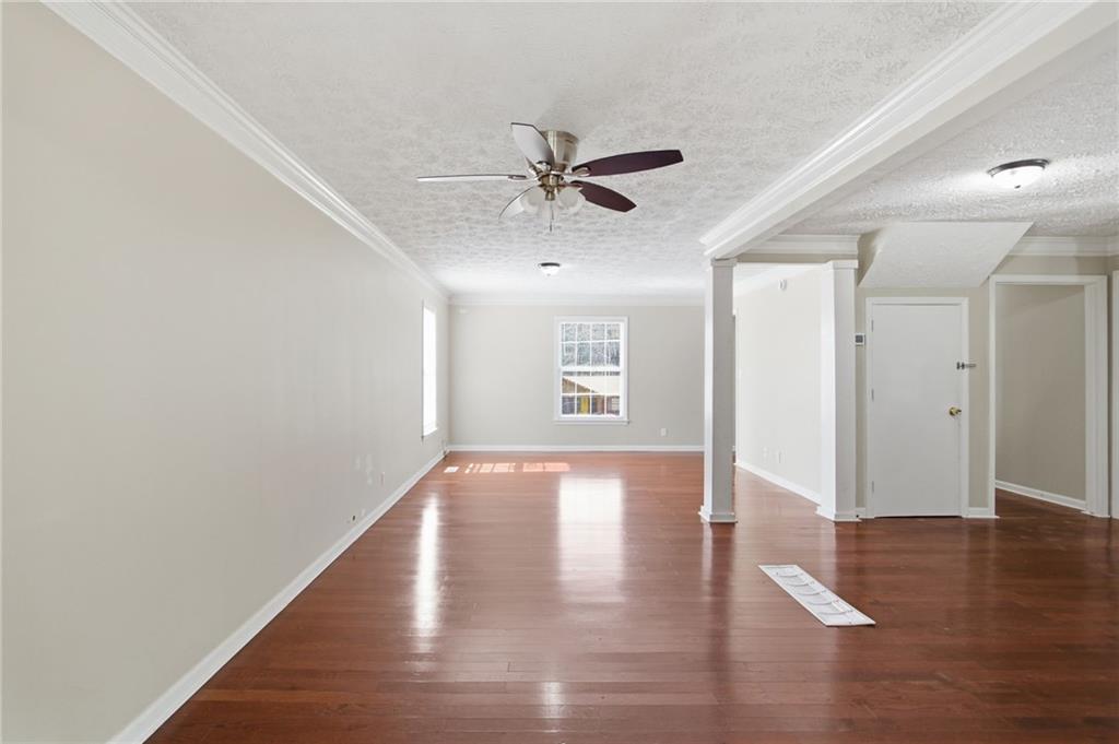 2366 Flint Rock Road Southwest Stone Mountain, GA 30087 - Photo 12 of 40 a view of a livingroom with wooden floor and a ceiling fan