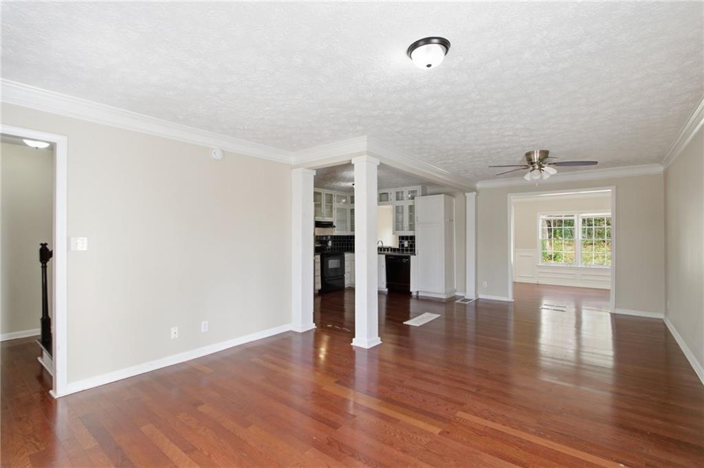 2366 Flint Rock Road Southwest Stone Mountain, GA 30087 - Photo 13 of 40 an empty room with wooden floor and windows
