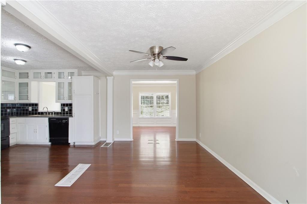 2366 Flint Rock Road Southwest Stone Mountain, GA 30087 - Photo 14 of 40 a view of an empty room with window and wooden floor
