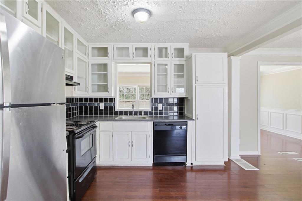 2366 Flint Rock Road Southwest Stone Mountain, GA 30087 - Photo 17 of 40 a kitchen with stainless steel appliances a refrigerator and a stove