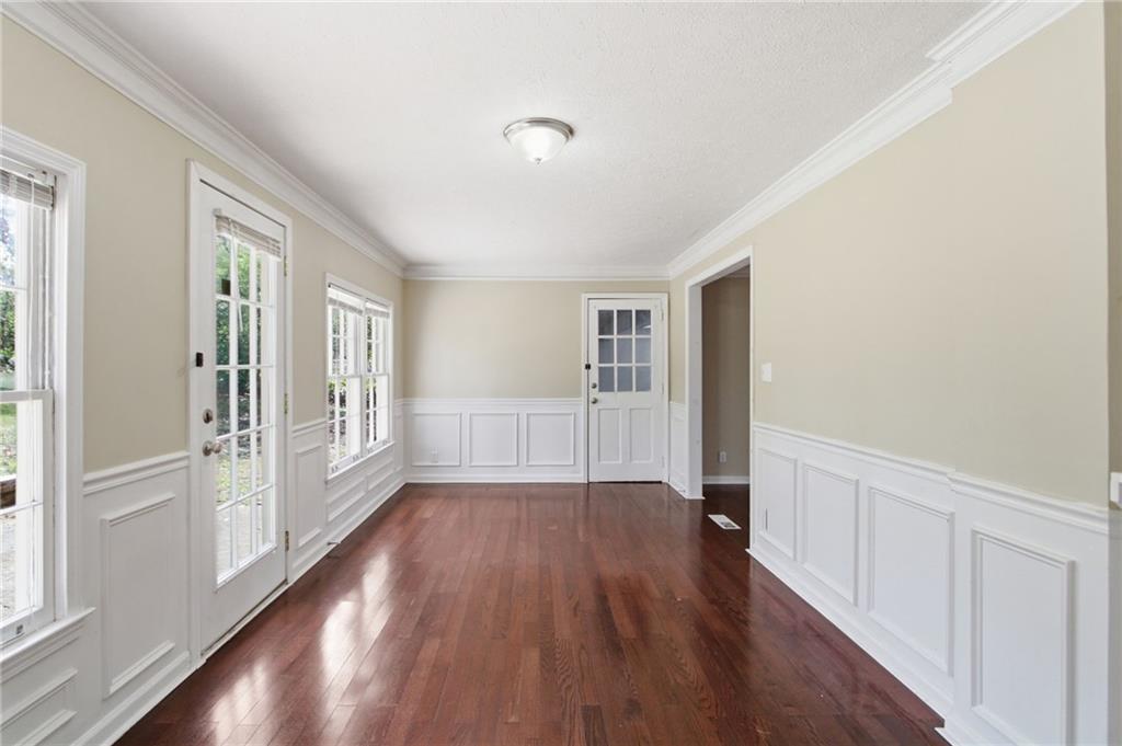 2366 Flint Rock Road Southwest Stone Mountain, GA 30087 - Photo 19 of 40 a view of an empty room with wooden floor and a window