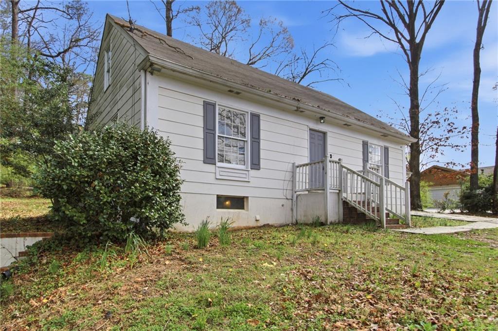 2366 Flint Rock Road Southwest Stone Mountain, GA 30087 - Photo 2 of 40 a view of a house with a yard