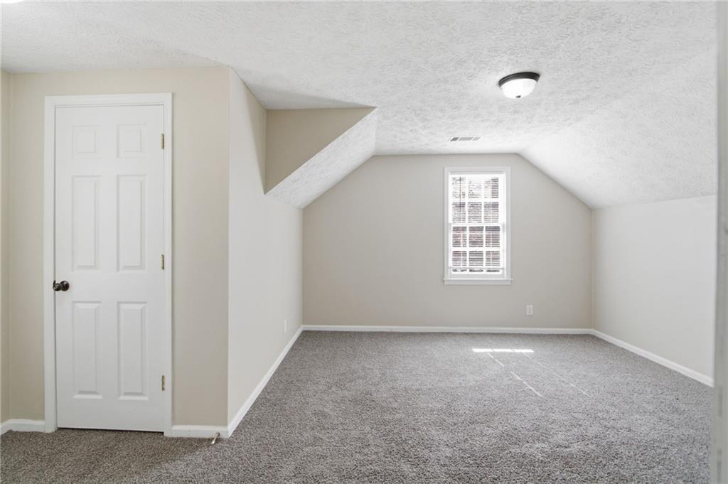 2366 Flint Rock Road Southwest Stone Mountain, GA 30087 - Photo 22 of 40 an empty room with windows and closet