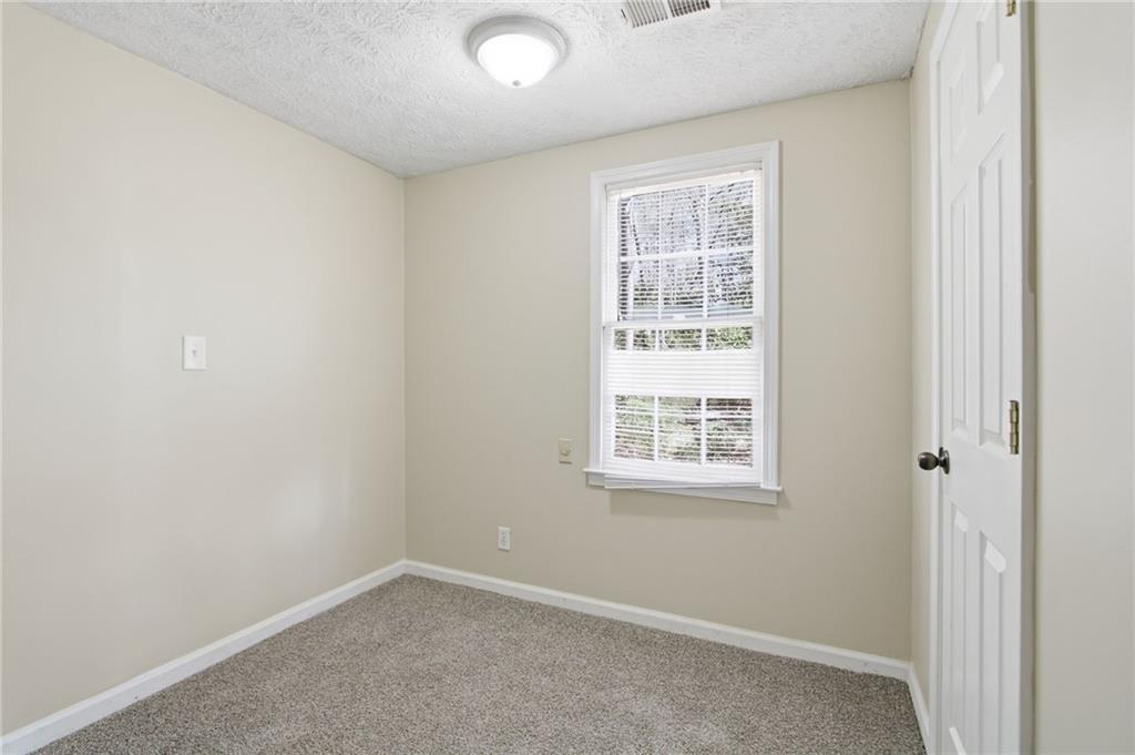 2366 Flint Rock Road Southwest Stone Mountain, GA 30087 - Photo 24 of 40 an empty room with a window