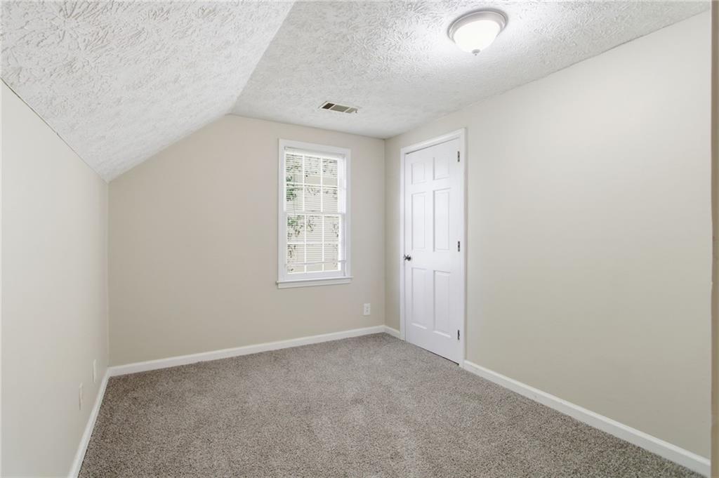 2366 Flint Rock Road Southwest Stone Mountain, GA 30087 - Photo 25 of 40 an empty room with windows and closet