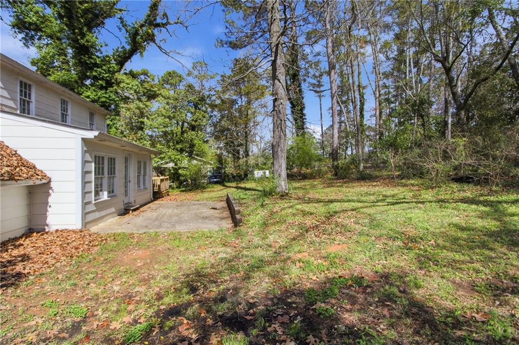 2366 Flint Rock Road Southwest Stone Mountain, GA 30087 - Photo 37 of 40 a view of a yard with plants and trees