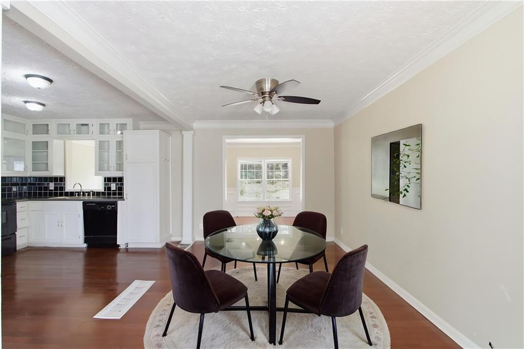2366 Flint Rock Road Southwest Stone Mountain, GA 30087 - Photo 5 of 40 a view of a dining room with furniture and wooden floor