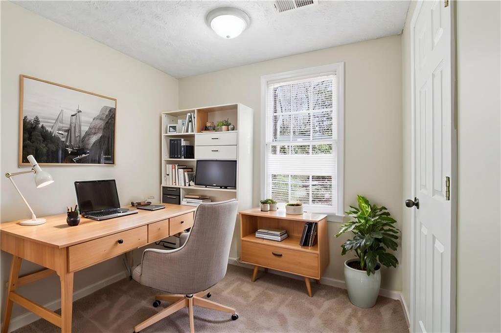 2366 Flint Rock Road Southwest Stone Mountain, GA 30087 - Photo 6 of 40 a view of a workspace with furniture and a window