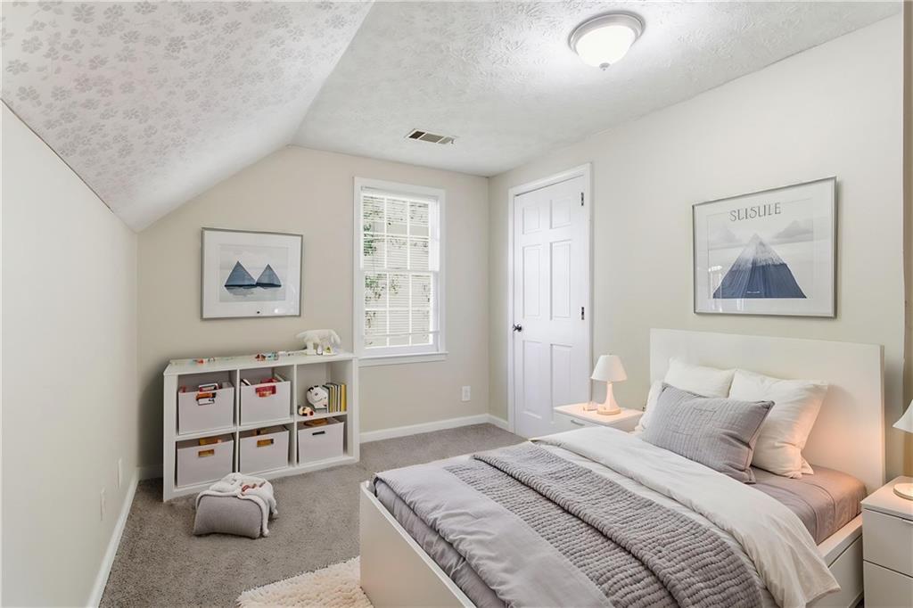 2366 Flint Rock Road Southwest Stone Mountain, GA 30087 - Photo 7 of 40 a bedroom with a bed and a couch