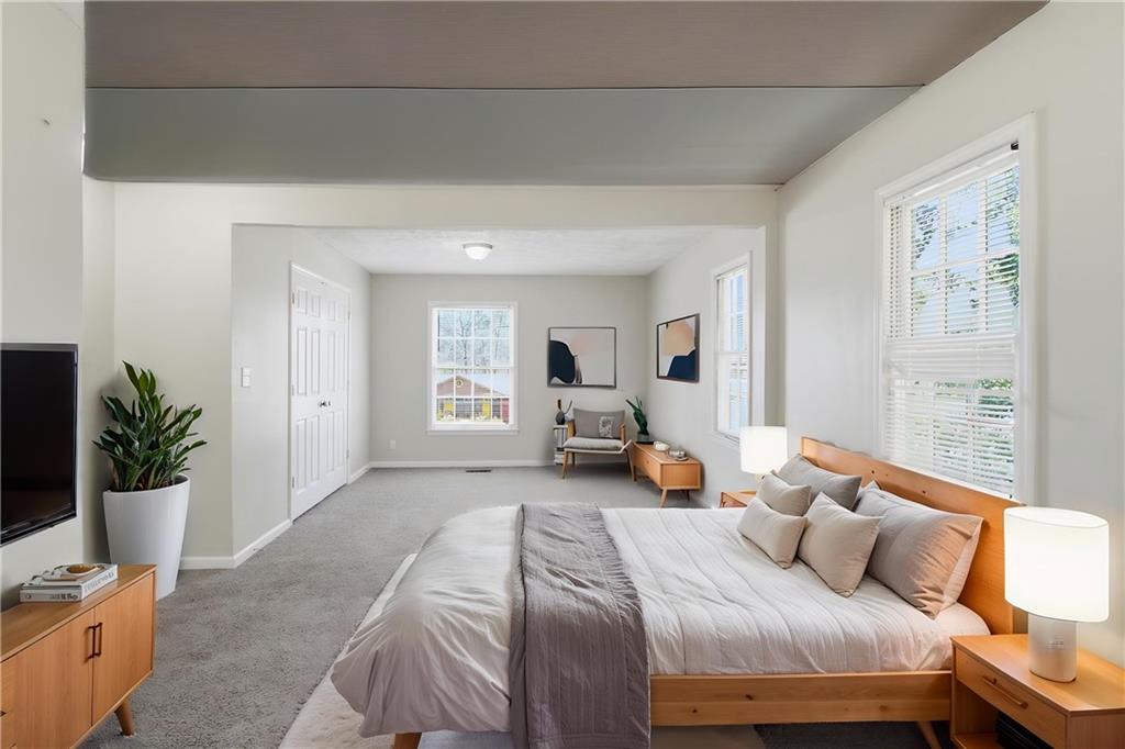 2366 Flint Rock Road Southwest Stone Mountain, GA 30087 - Photo 8 of 40 a bedroom with a bed and wooden floor