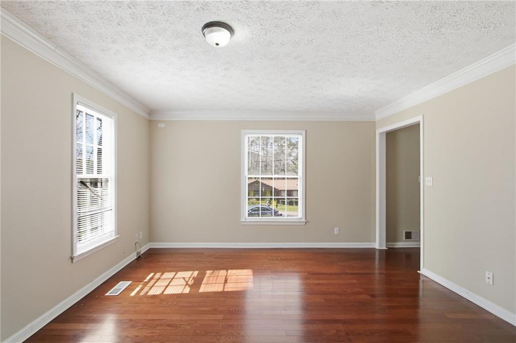 2366 Flint Rock Road Southwest Stone Mountain, GA 30087 - Photo 9 of 40 an empty room with wooden floor and windows