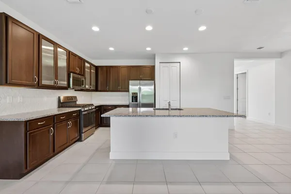 a view of a kitchen with a sink and a refrigerator
