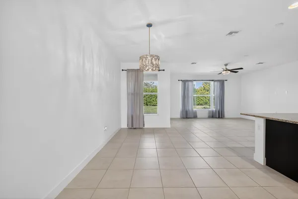 a living room with lots of furniture and view of kitchen