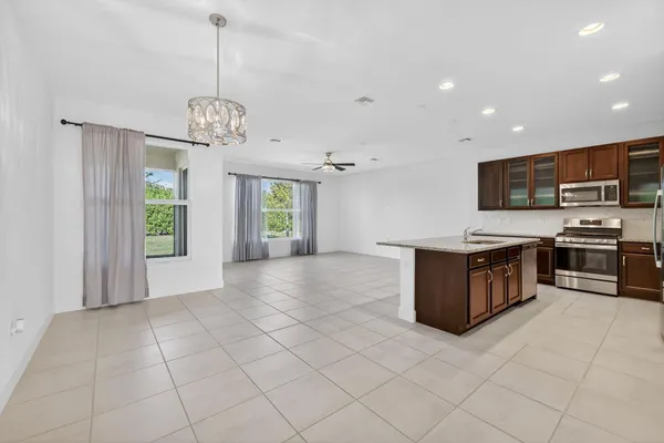 a kitchen with stainless steel appliances granite countertop a sink and a stove