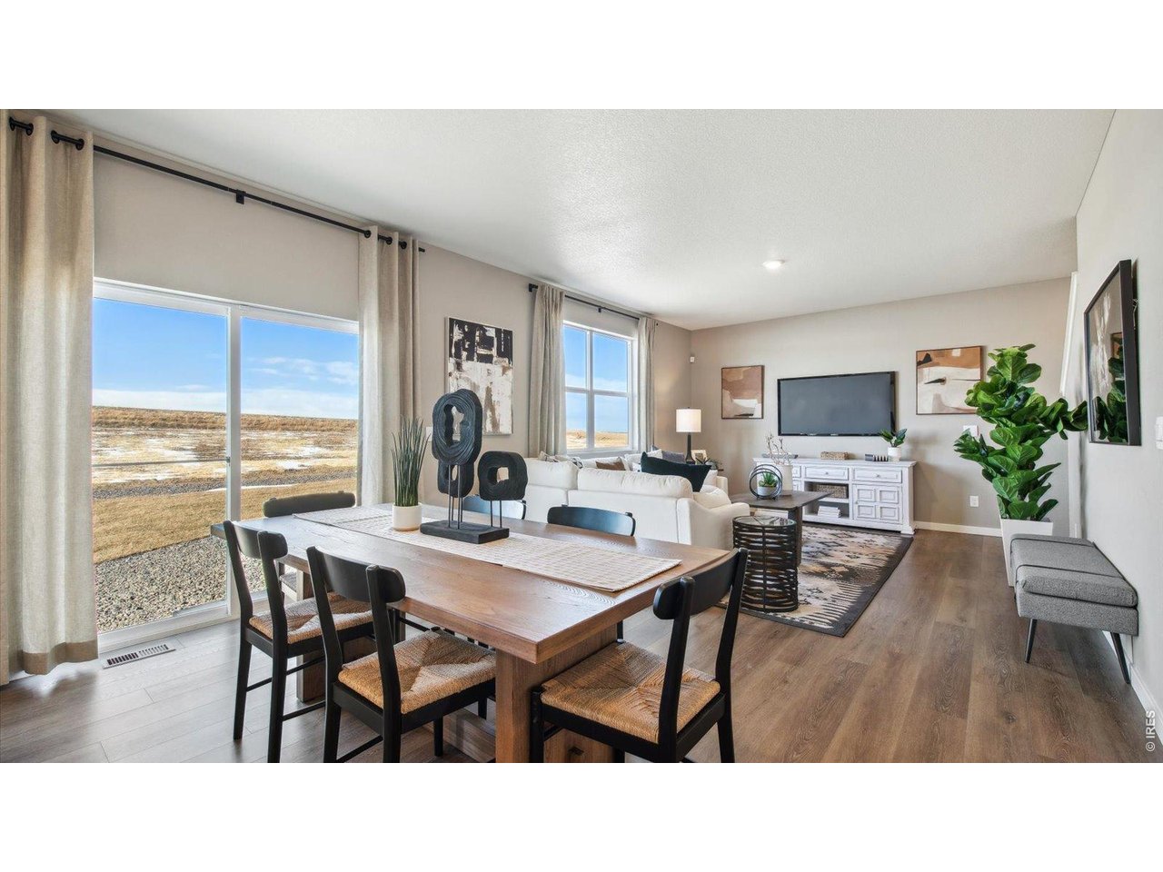 2338 Base Street Fort Lupton, CO 80621 - Photo 16 of 24 a living room with furniture a dining table and a large window
