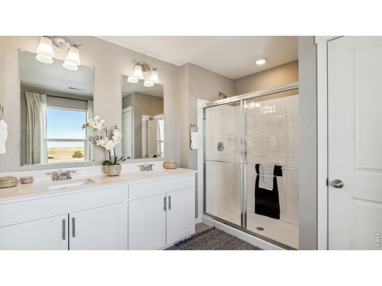 2338 Base Street Fort Lupton, CO 80621 - Photo 18 of 24 a bathroom with a sink double vanity shower and a mirror