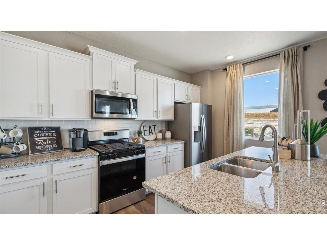 2338 Base Street Fort Lupton, CO 80621 - Photo 8 of 24 a kitchen with a sink stove and refrigerator