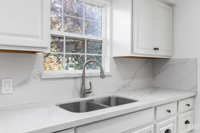 a kitchen with a sink and cabinets