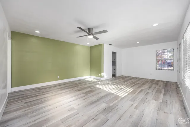 wooden floor in an empty room with a window