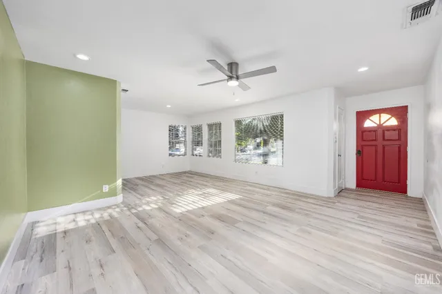 wooden floor in an empty room with a window