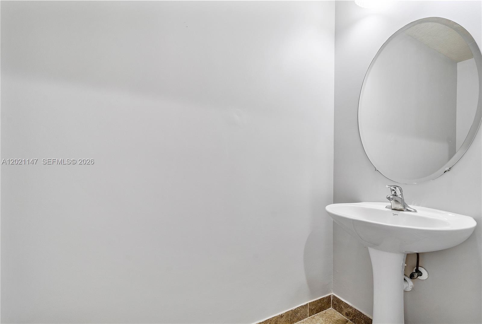 5930 Abbey Road Tamarac, FL 33321 - Photo 14 of 26 a bathroom with a sink and a mirror