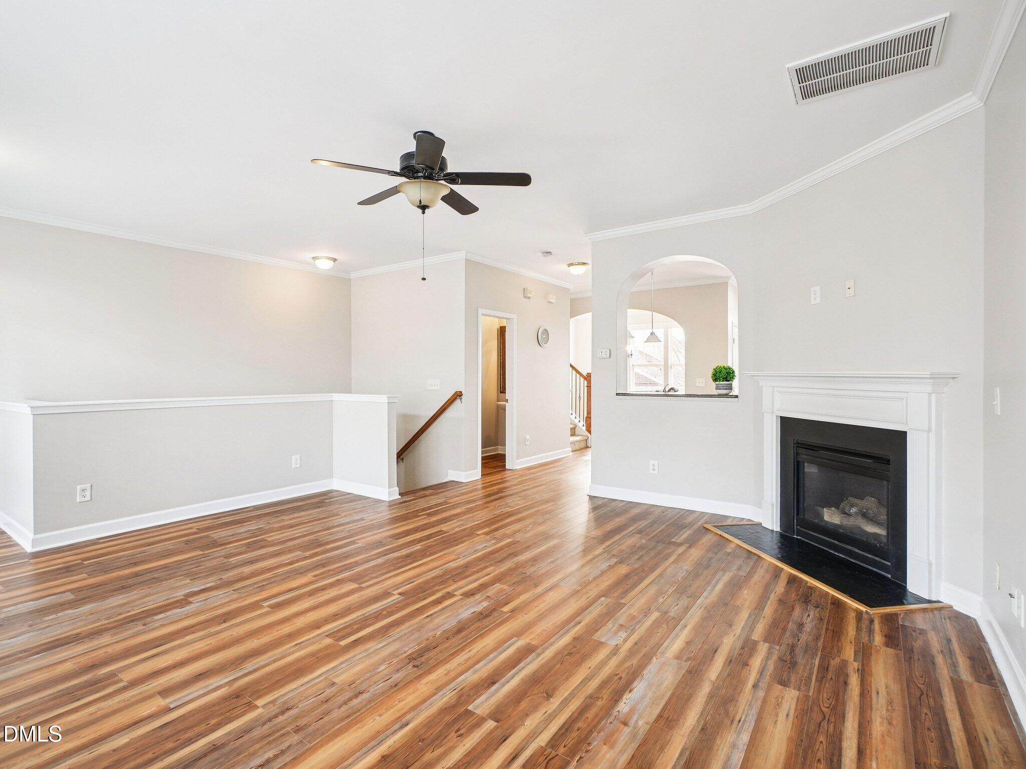 9238 Wooden Road Raleigh, NC 27617 - Photo 11 of 45 a view of empty room with wooden floor and fireplace