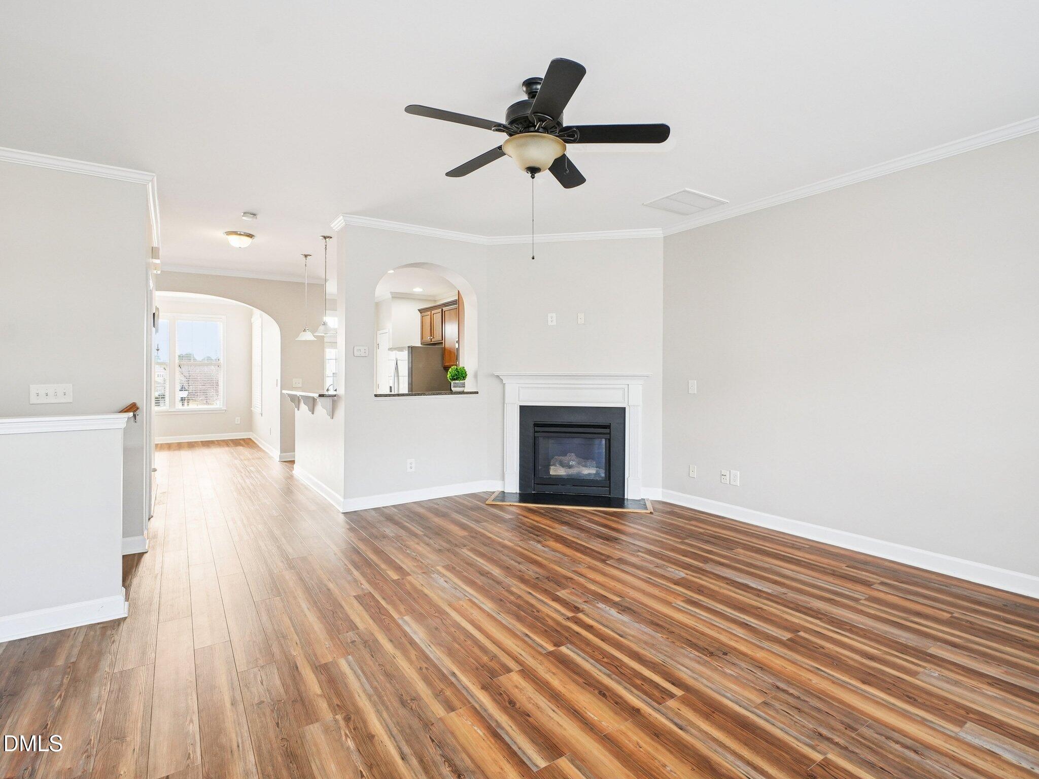 9238 Wooden Road Raleigh, NC 27617 - Photo 16 of 45 a view of empty room with wooden floor and fireplace