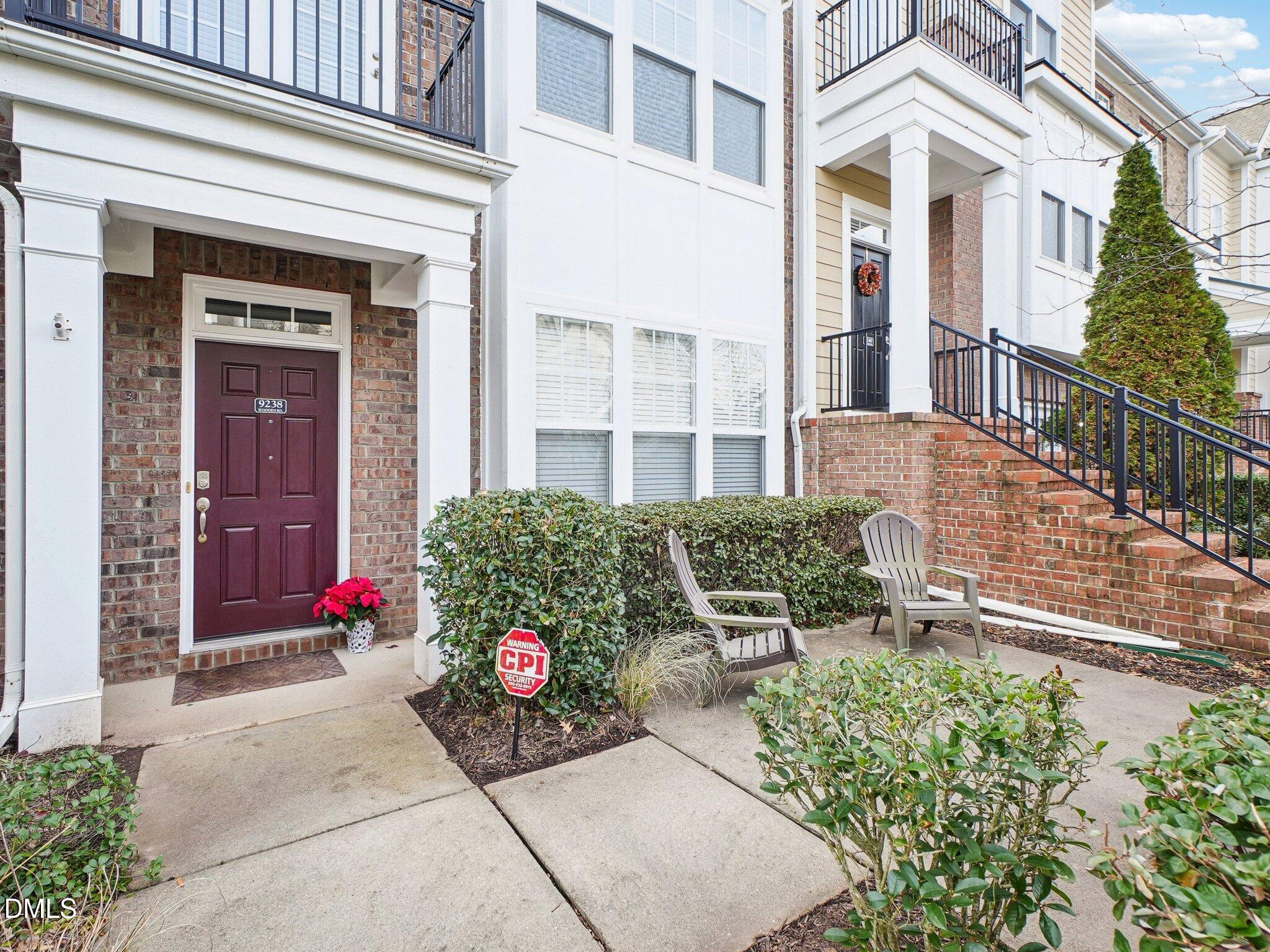 9238 Wooden Road Raleigh, NC 27617 - Photo 2 of 45 front view of a brick house with a yard