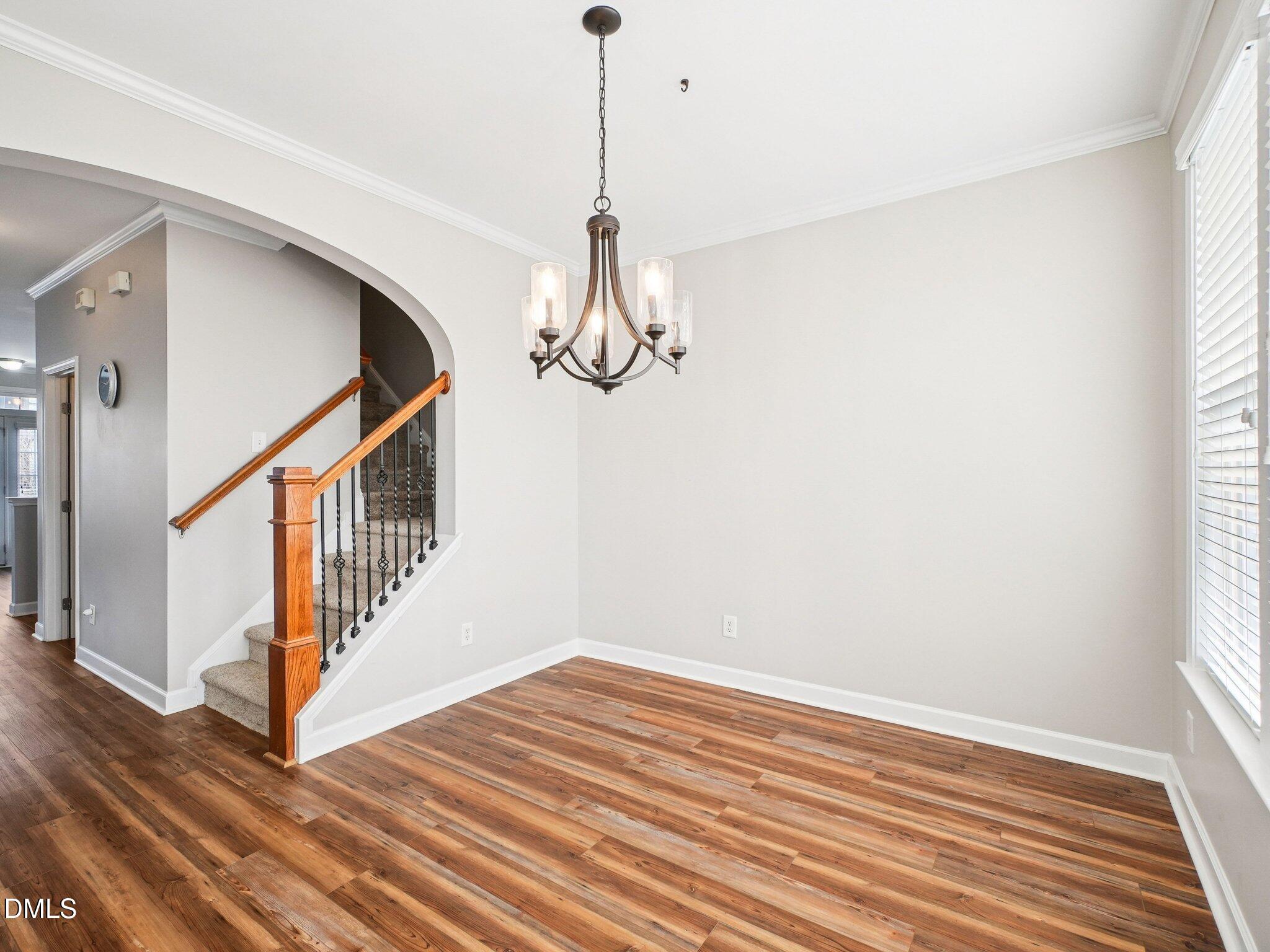9238 Wooden Road Raleigh, NC 27617 - Photo 25 of 45 a view of a room with wooden floor and white walls