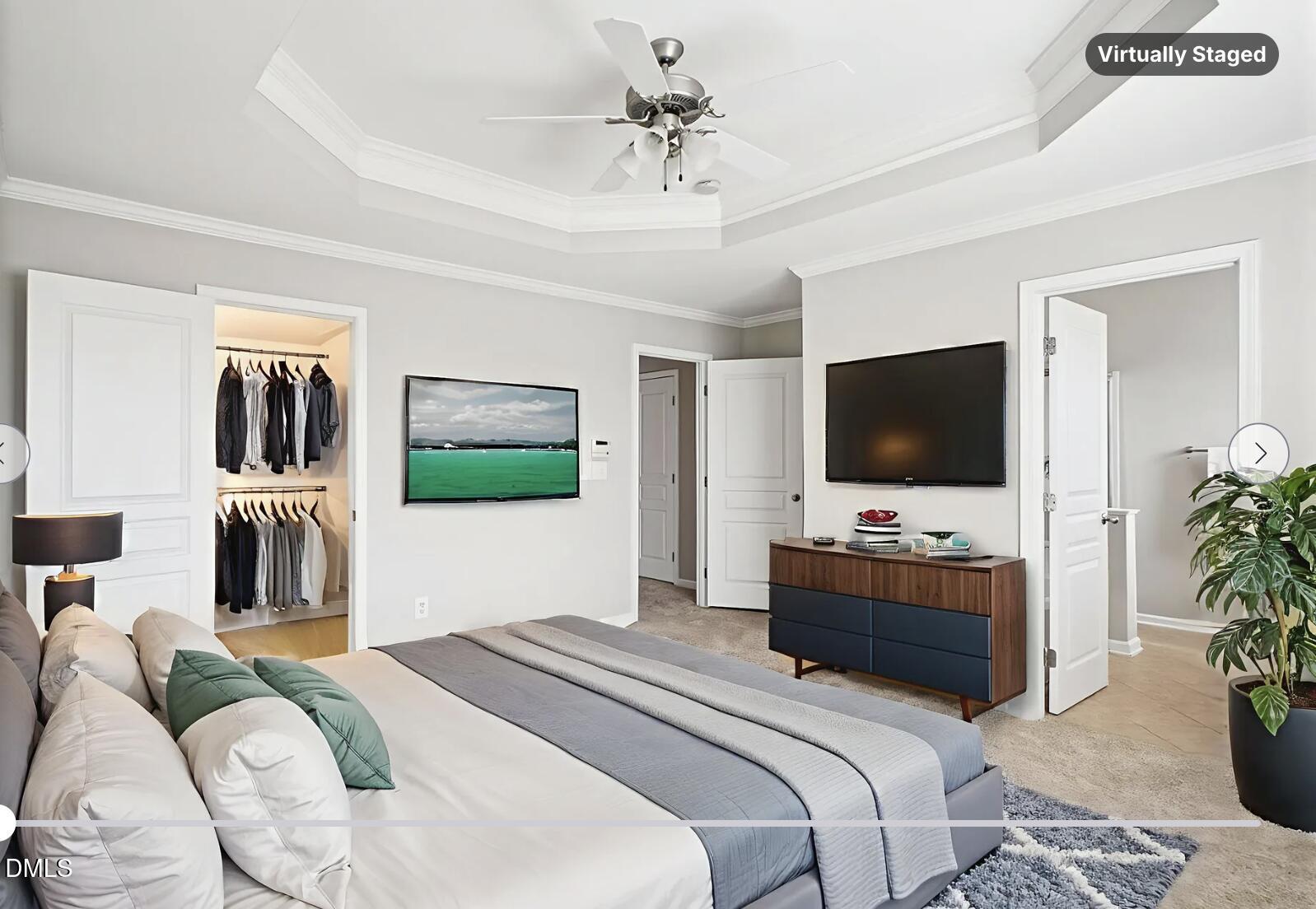 9238 Wooden Road Raleigh, NC 27617 - Photo 28 of 45 a bedroom with bed a flat screen tv and a couch