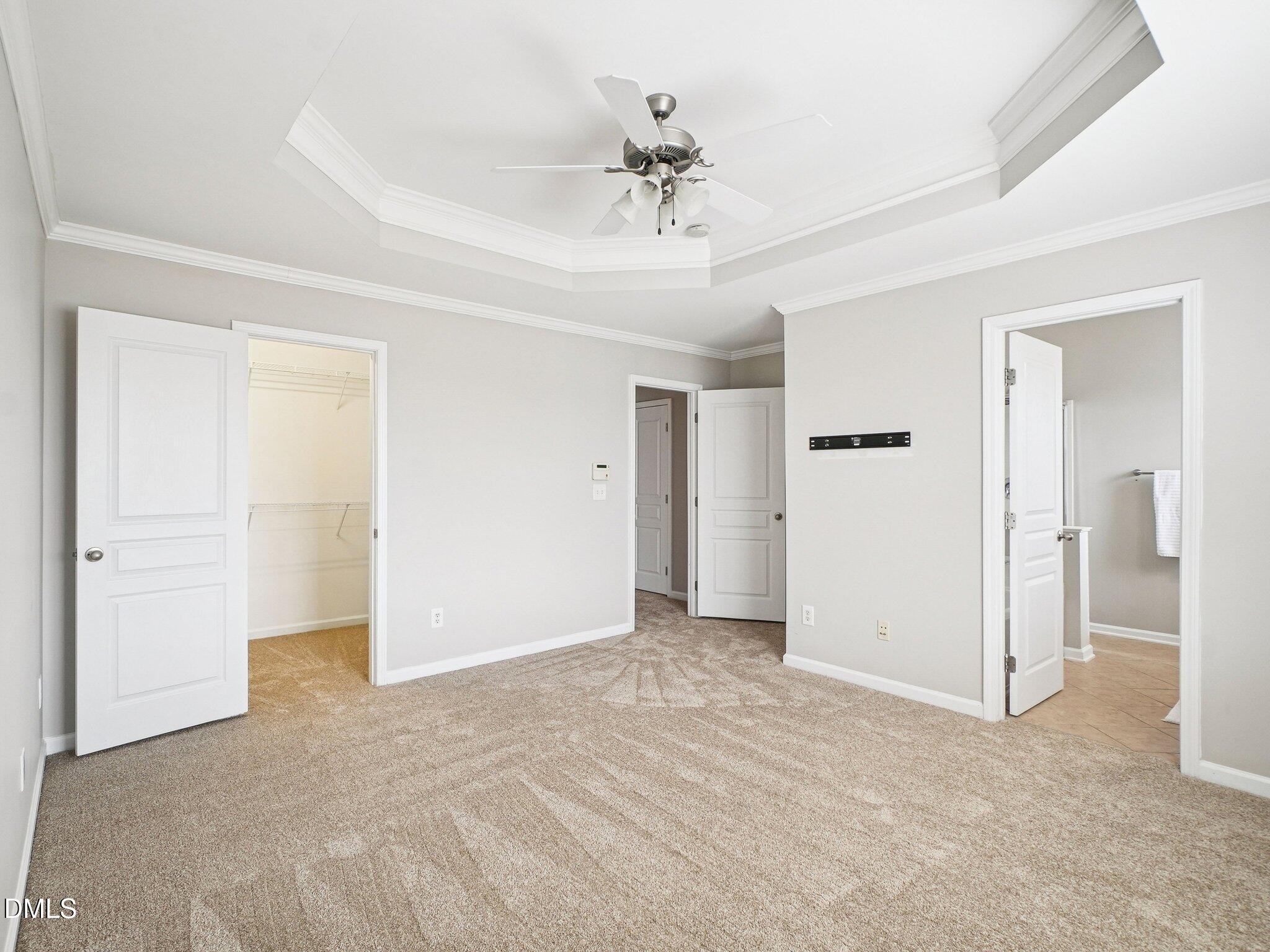 9238 Wooden Road Raleigh, NC 27617 - Photo 29 of 45 an empty room with closet and a ceiling fan
