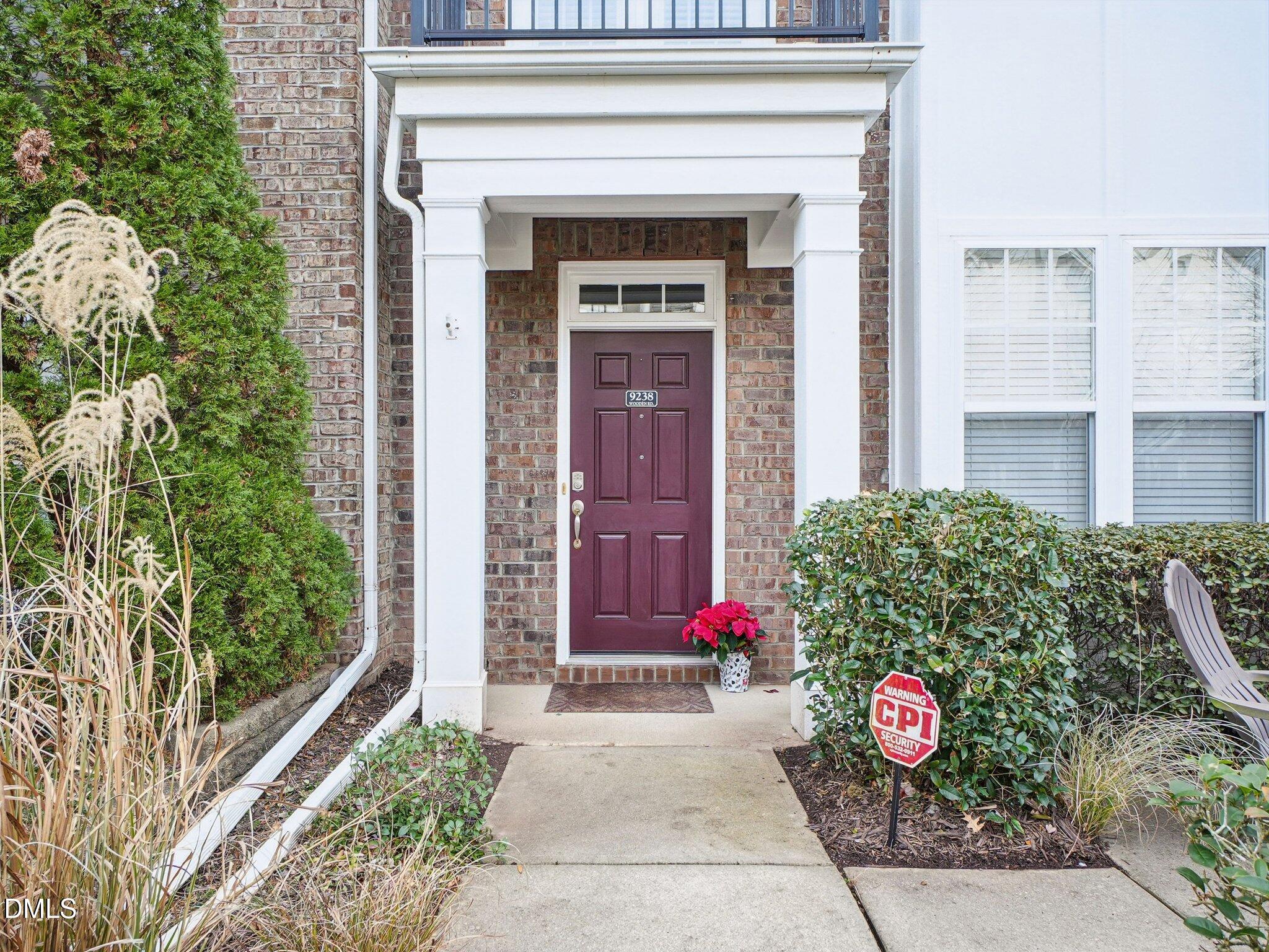 9238 Wooden Road Raleigh, NC 27617 - Photo 3 of 45 a front view of a house with a bunch of flowers