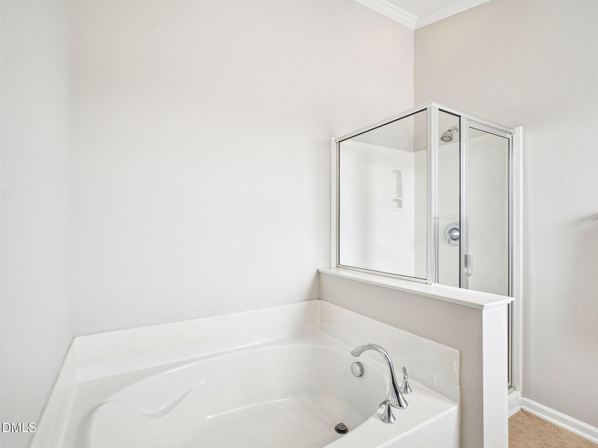9238 Wooden Road Raleigh, NC 27617 - Photo 31 of 45 a bathroom with a bathtub