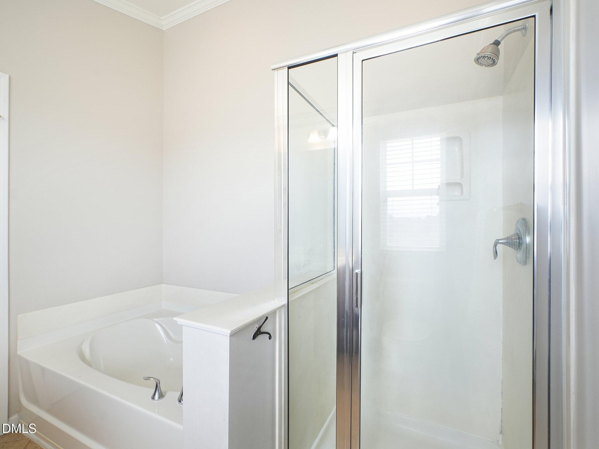 9238 Wooden Road Raleigh, NC 27617 - Photo 32 of 45 a bathroom with a tub and shower