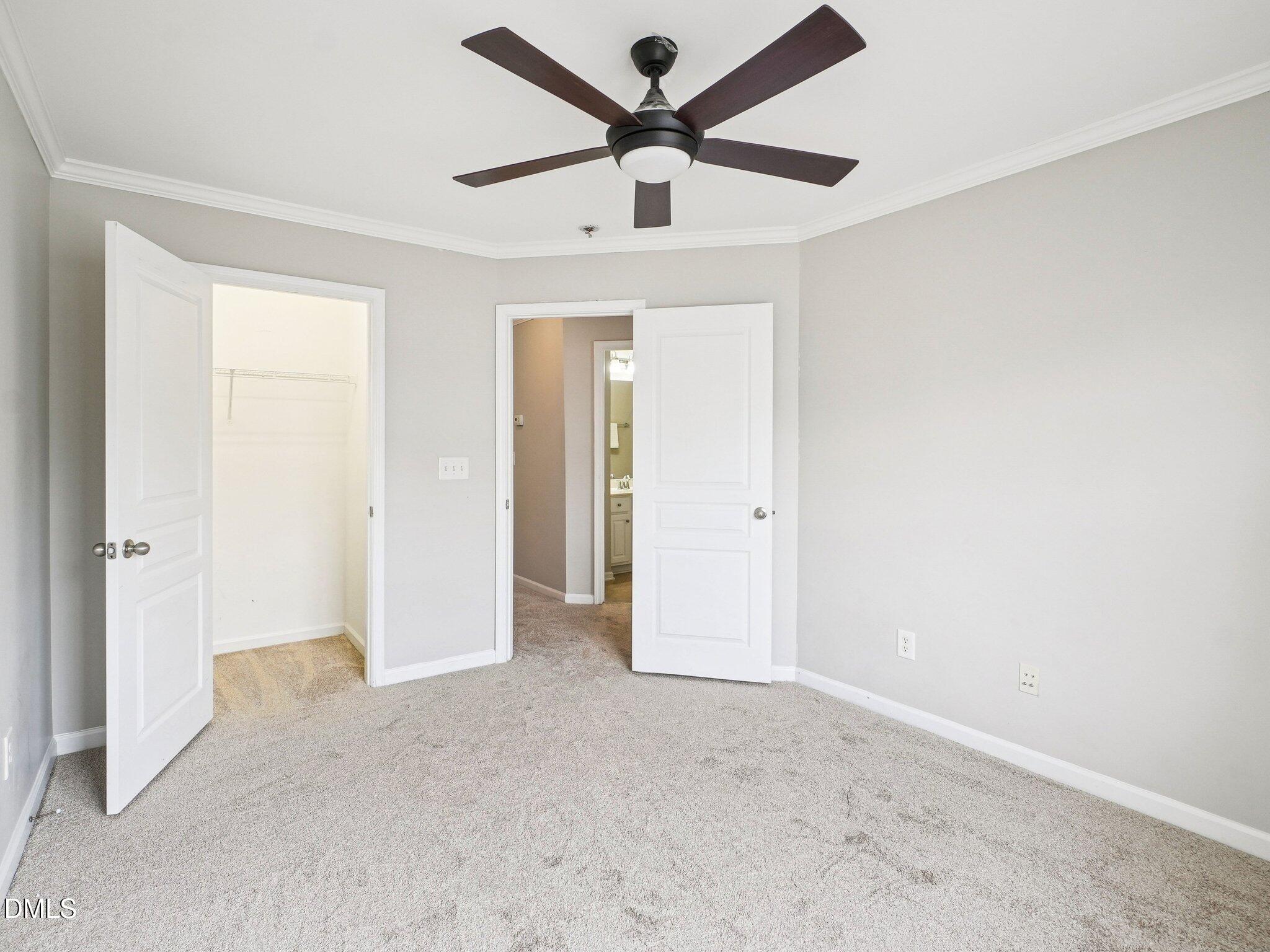 9238 Wooden Road Raleigh, NC 27617 - Photo 35 of 45 an empty room and chandelier fan