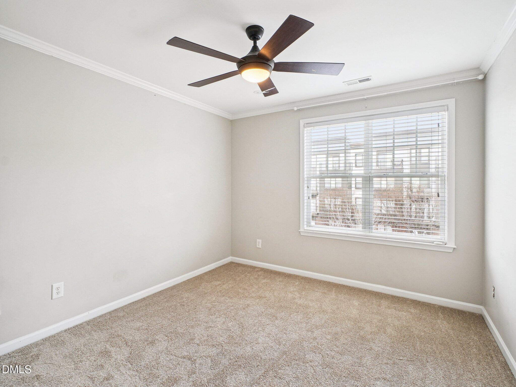 9238 Wooden Road Raleigh, NC 27617 - Photo 36 of 45 an empty room with a window and a fan