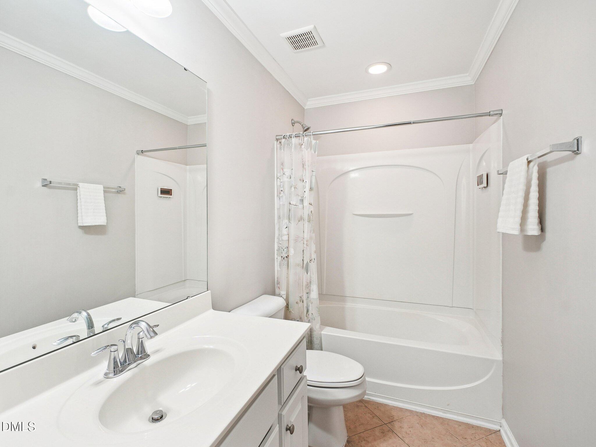 9238 Wooden Road Raleigh, NC 27617 - Photo 38 of 45 a bathroom with a sink toilet and shower