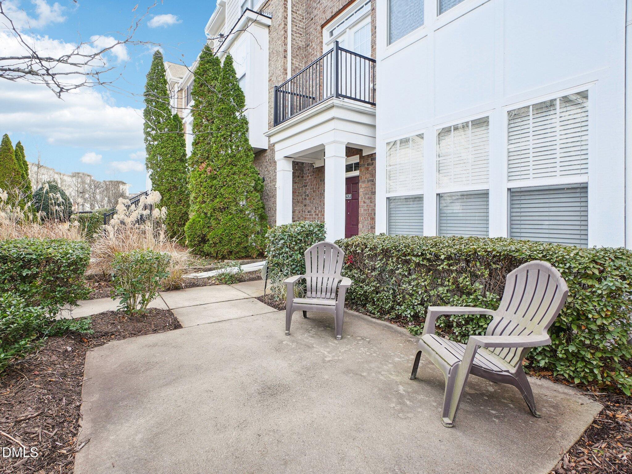 9238 Wooden Road Raleigh, NC 27617 - Photo 4 of 45 a view of a patio with couches table and chairs and potted plants