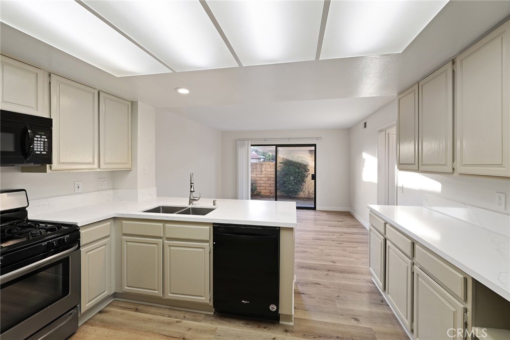33666 Surfside Drive, Unit 38 Dana Point, CA 92629 - Photo 12 of 39 a kitchen with a sink stove and cabinets