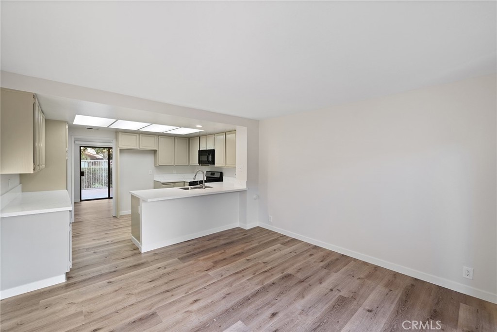33666 Surfside Drive, Unit 38 Dana Point, CA 92629 - Photo 17 of 39 a view of a kitchen with wooden floor and a sink