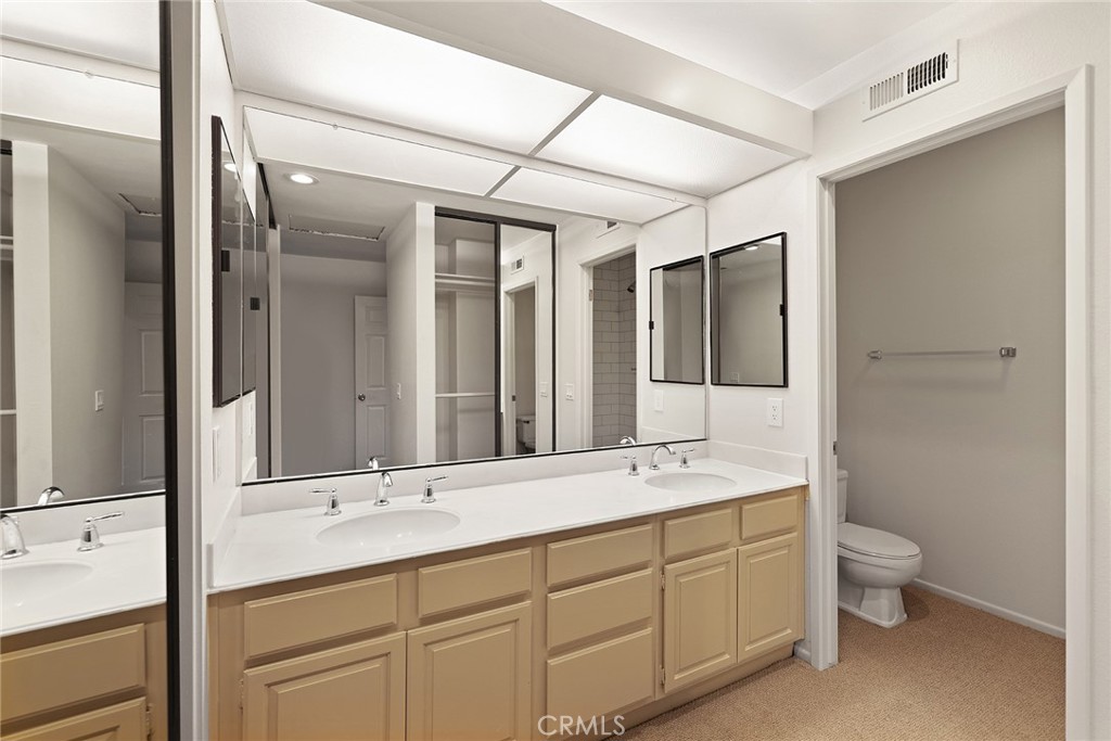 33666 Surfside Drive, Unit 38 Dana Point, CA 92629 - Photo 25 of 39 a spacious bathroom with a double vanity sink mirror and double